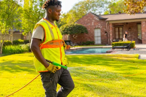 Technician treating a lawn in Baton Rouge, LA