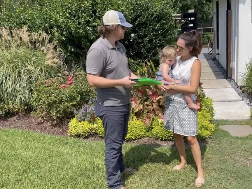 Dave, Treppendahl's landscape designer, going over a landscape plan with a homeowner and her daughter in Baton Rouge, LA