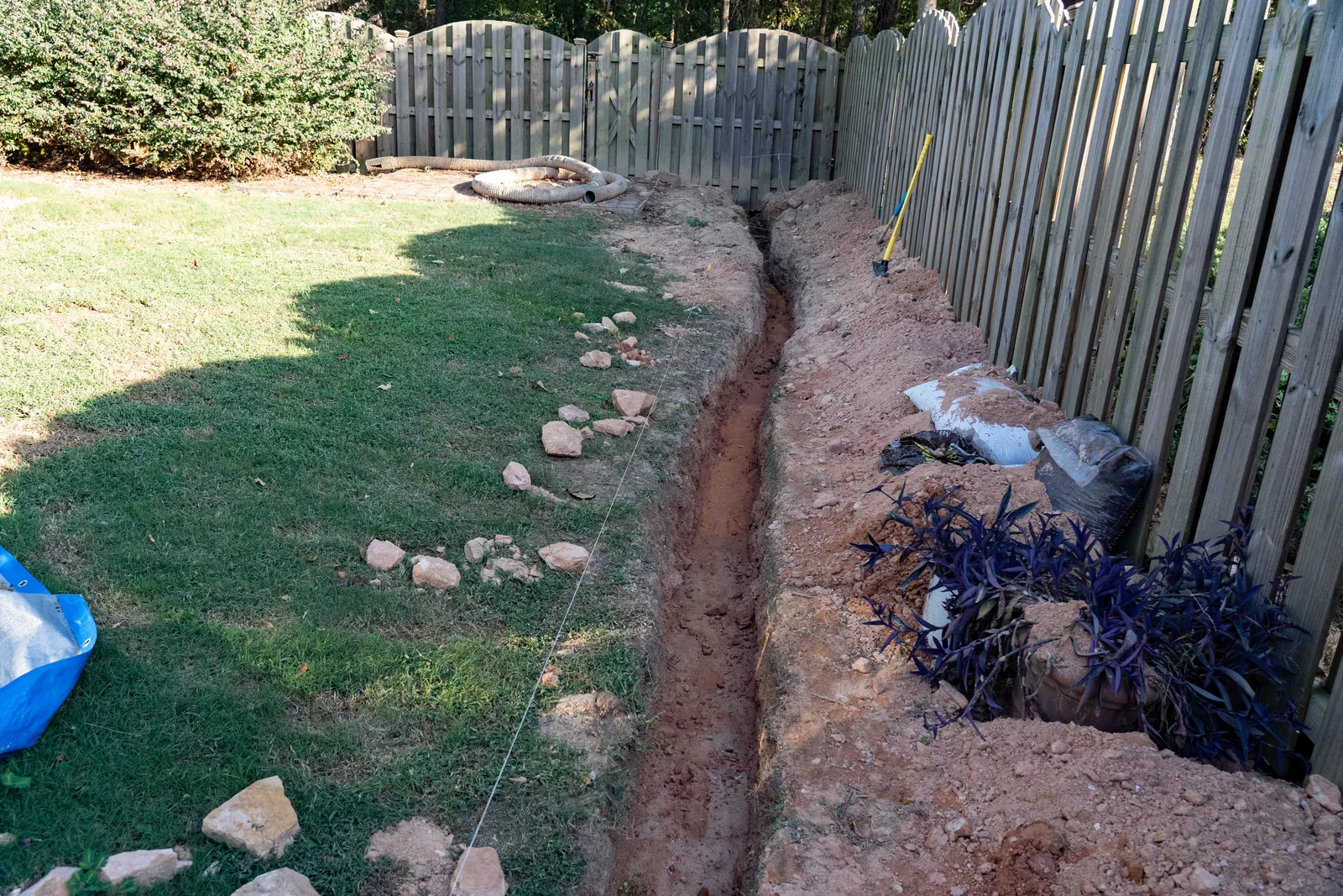 Drainage trench dug along a backyard fence line in Baton Rouge, LA