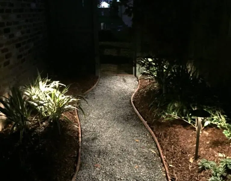 Lit gravel path between planted beds in Baton Rouge, LA